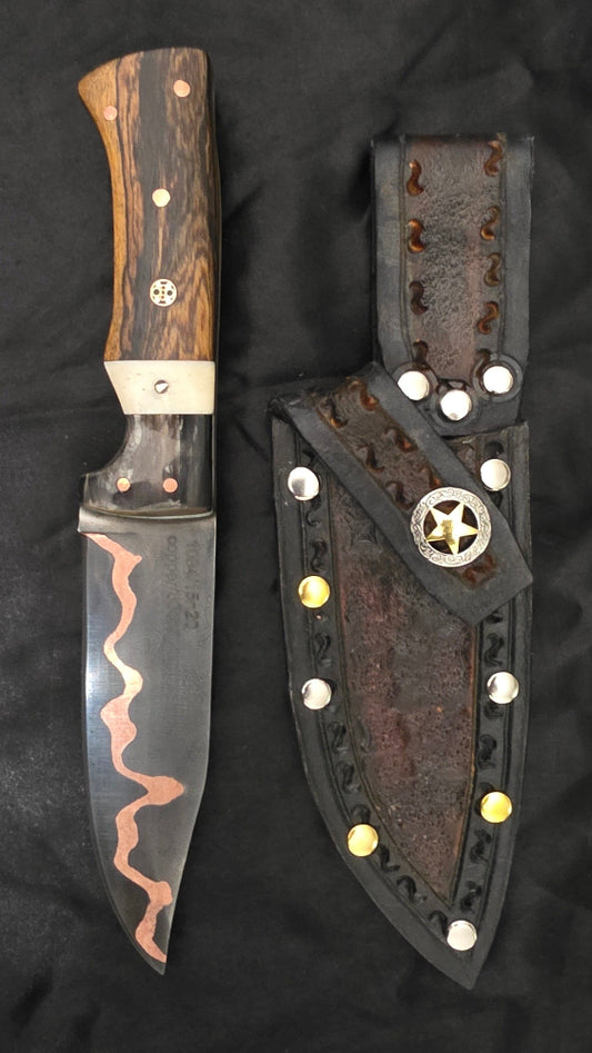 Decorative knife with wooden handle and metal blade on a black background